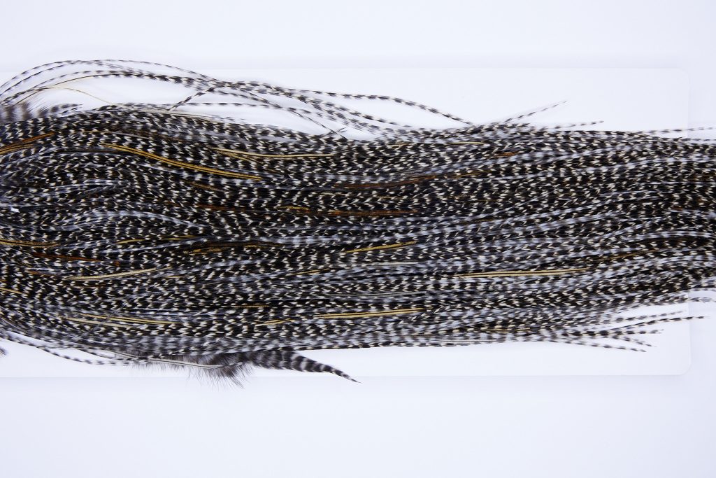 324 - Heritage Dry Fly Hackle, Grizzly Variant #2 Grade Rooster Saddle, Ties Sizes 16-18